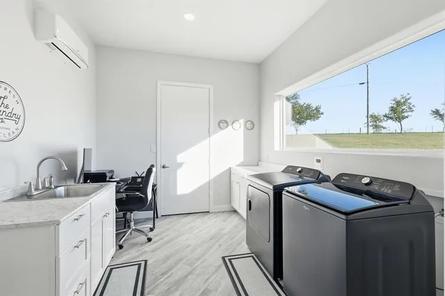 a living room with furniture large window and wooden floor