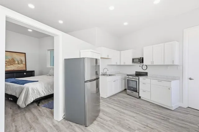 a view of a house with a big yard and large trees