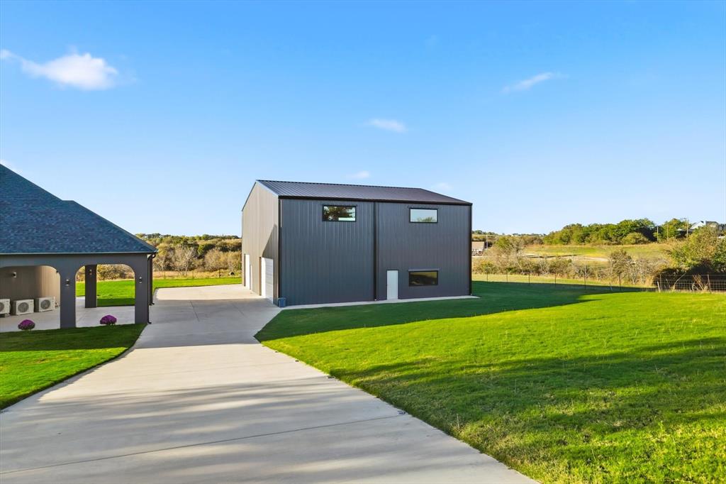 145 ROCK Court Decatur, TX 76234 - Photo 28 of 40 a view of a house with a yard and a garage