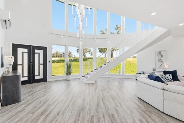 a view of entryway and hall with wooden floor