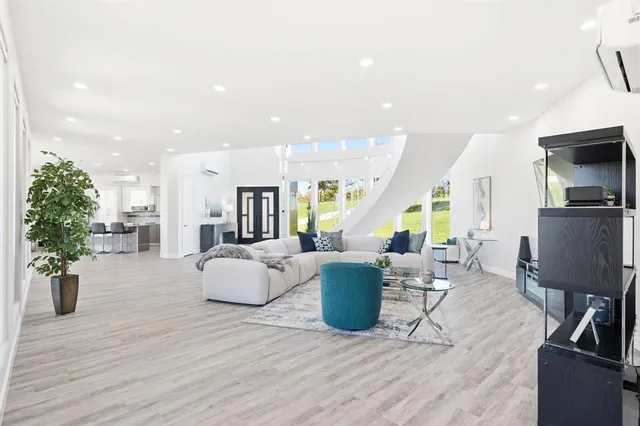 a living room with lots of furniture and kitchen view