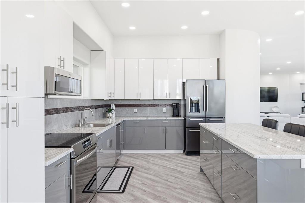 145 ROCK Court Decatur, TX 76234 - Photo 9 of 40 a kitchen with stainless steel appliances granite countertop a sink stove and refrigerator