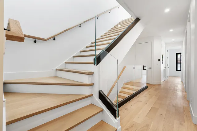 a view of entryway and hall with wooden floor