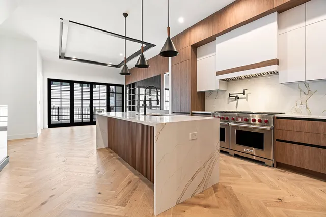 a kitchen with stainless steel appliances granite countertop a stove and a refrigerator