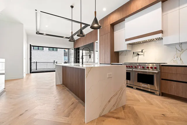 a kitchen with stainless steel appliances granite countertop a sink and cabinets