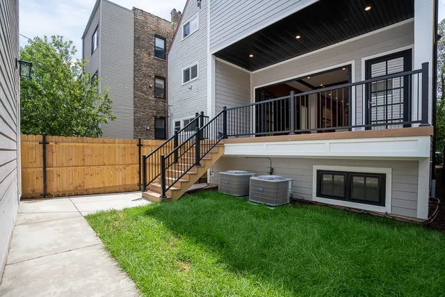 a view of a house with a yard and furniture