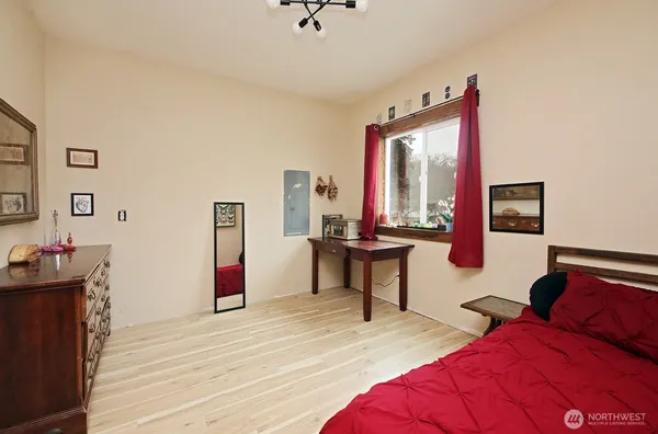 a spacious bedroom with a bed and a dresser