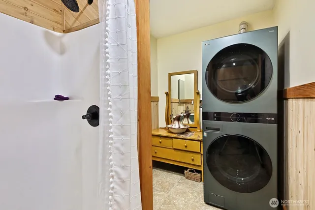 a spacious bedroom with a bed and a dresser