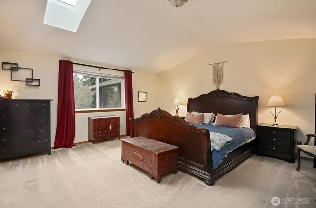 a bedroom with a large bed and a large window