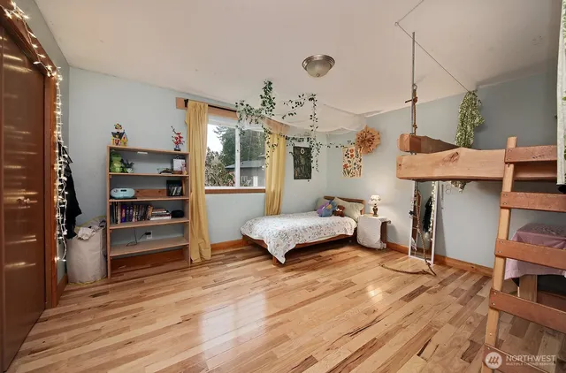 a bedroom with two beds and a dresser