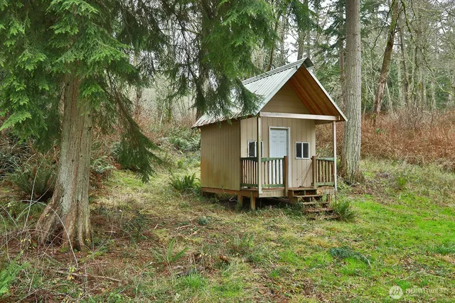a view of a house with a backyard and a slide
