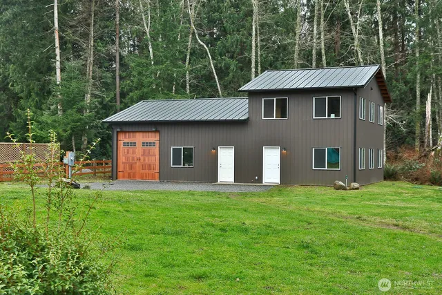 a living room with furniture a window and a flat screen tv