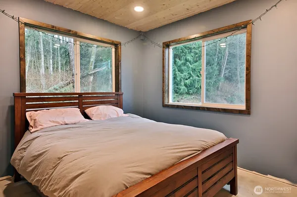 a bedroom with furniture and wooden floor