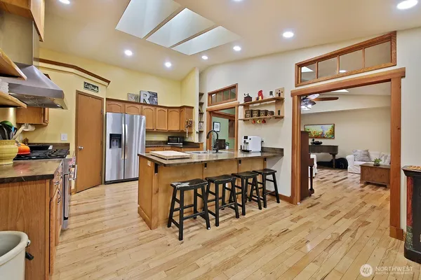a kitchen with stainless steel appliances granite countertop a stove a sink and a granite counter tops