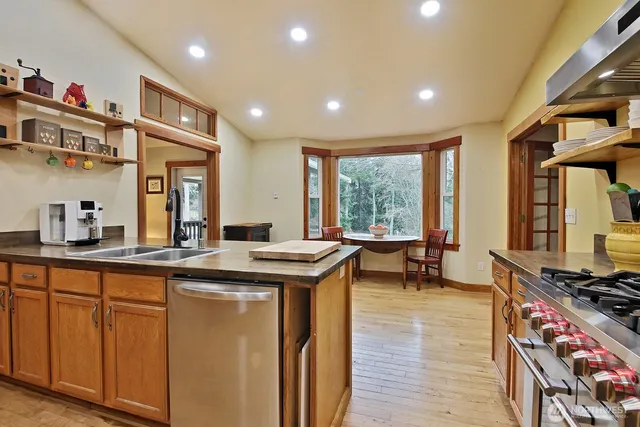 a kitchen with stainless steel appliances granite countertop a stove a sink and a granite counter tops
