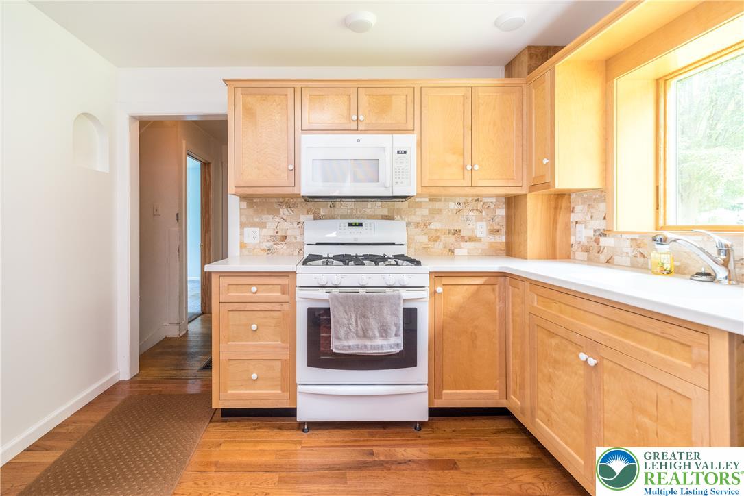 1815 Leithsville Road Hellertown, PA 18055 - Photo 5 of 38 Blonde wood cabinetry paired with a white countertop creates a bright and functional cooking space.