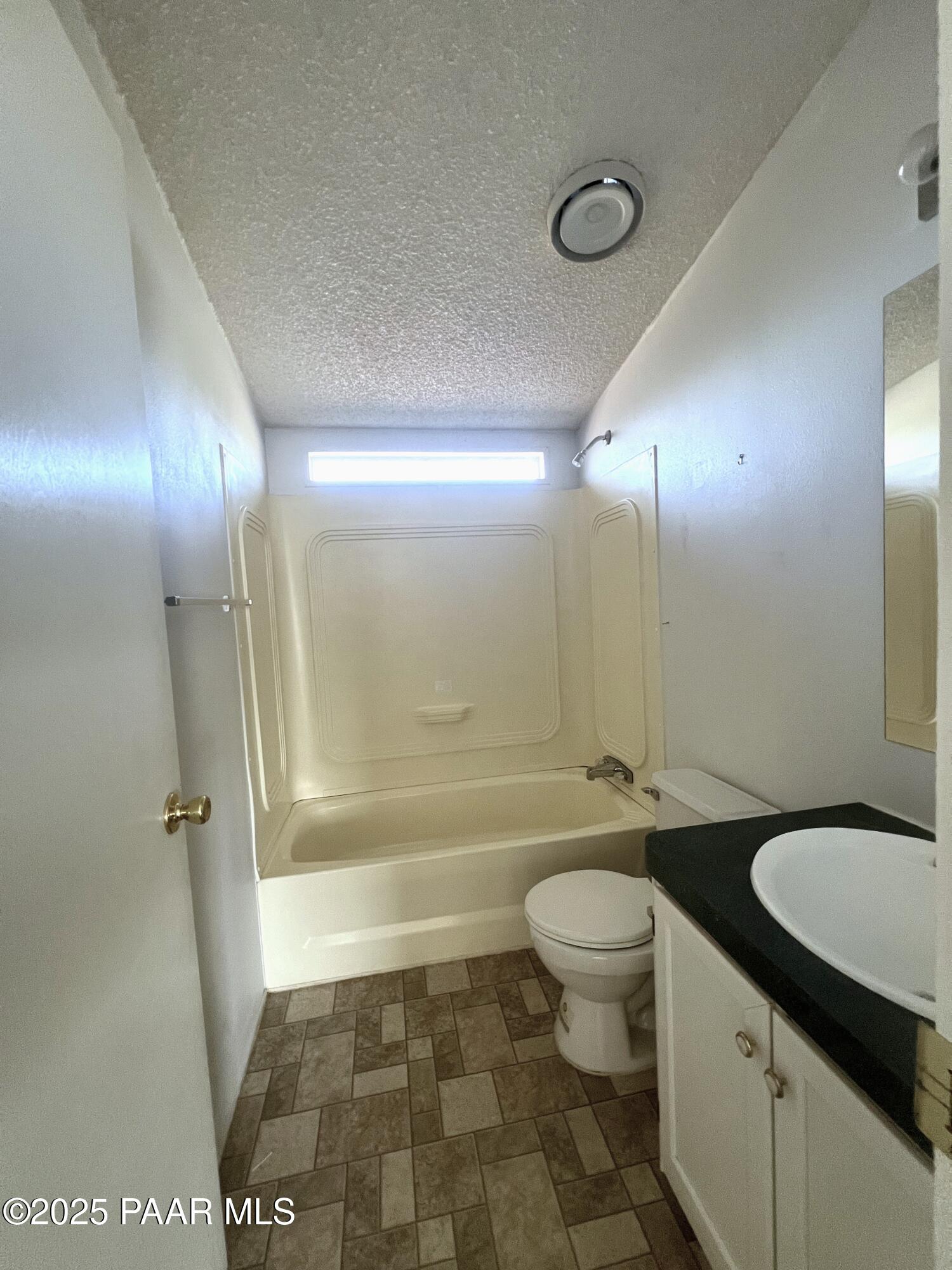 0 Basconia Lane Seligman, AZ 86337 - Photo 18 of 28 a bathroom with a granite countertop sink toilet mirror and a bathtub