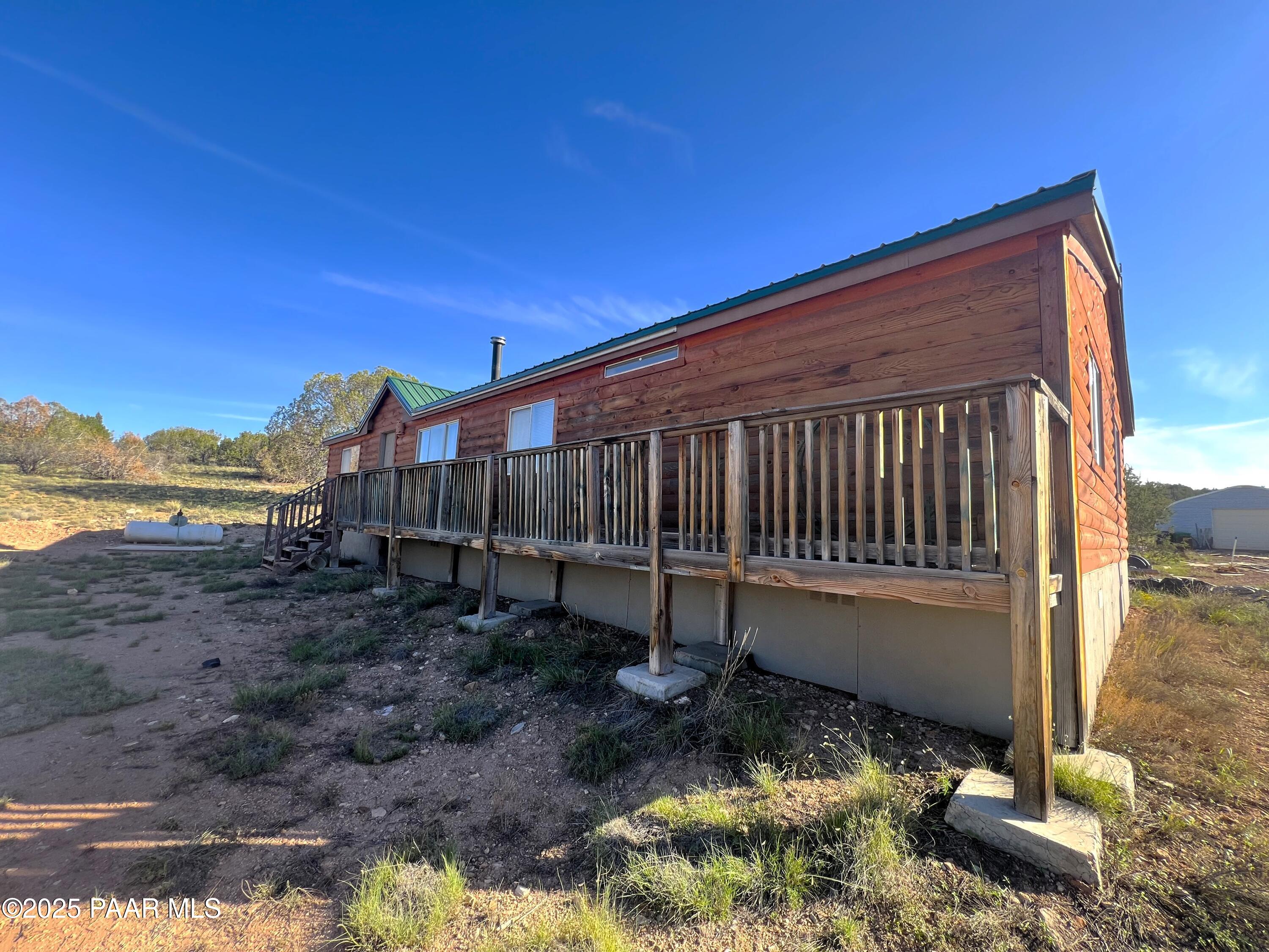 0 Basconia Lane Seligman, AZ 86337 - Photo 2 of 28 a backyard of a house with wooden floor outdoor seating and yard in the back