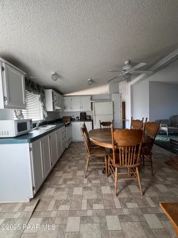 a kitchen with a dining table chairs and a counter top space