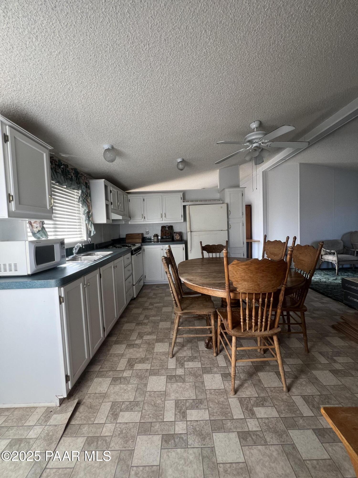 0 Basconia Lane Seligman, AZ 86337 - Photo 5 of 28 a kitchen with a dining table chairs and a counter top space