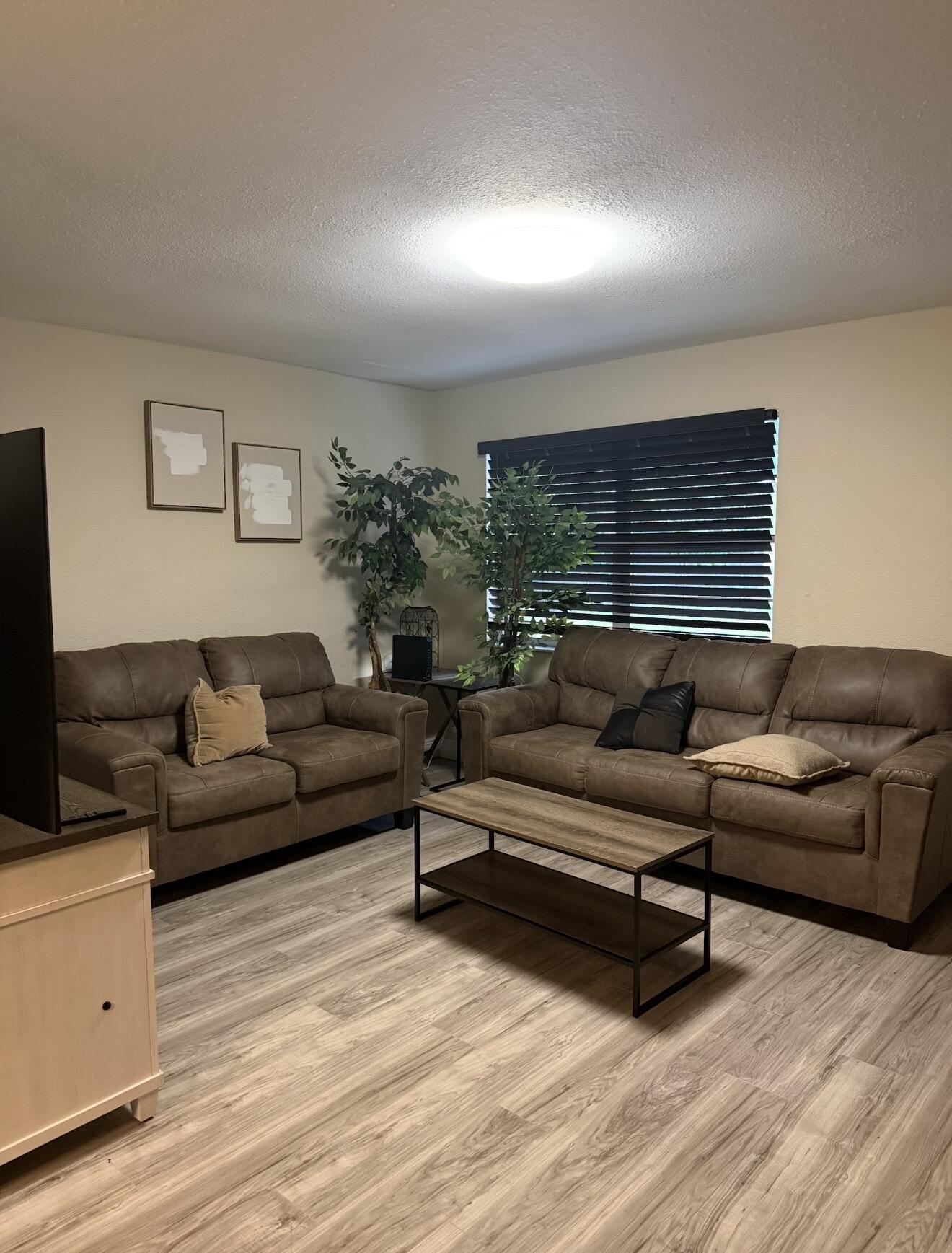 1604 Southeast Apache Avenue Stuart, FL 34994 - Photo 4 of 12 a living room with furniture and a flat screen tv
