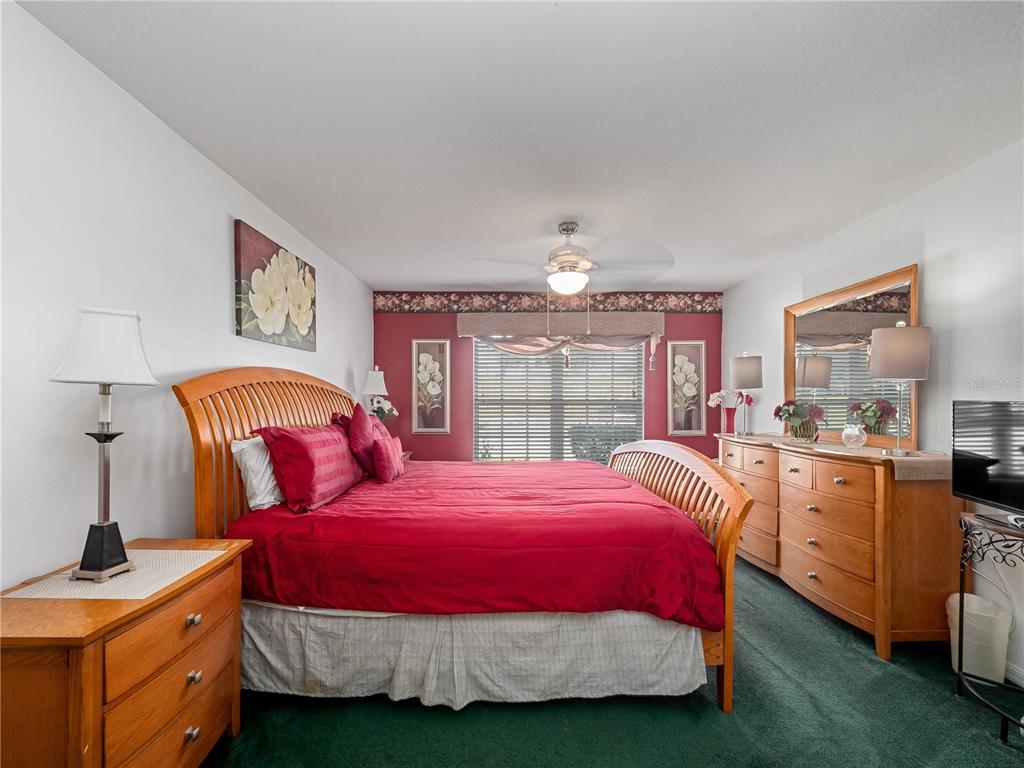 723 Wildflower Road Davenport, FL 33837 - Photo 17 of 34 a bedroom with a bed and a window