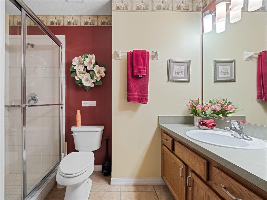 723 Wildflower Road Davenport, FL 33837 - Photo 18 of 34 a bathroom with a sink toilet and shower