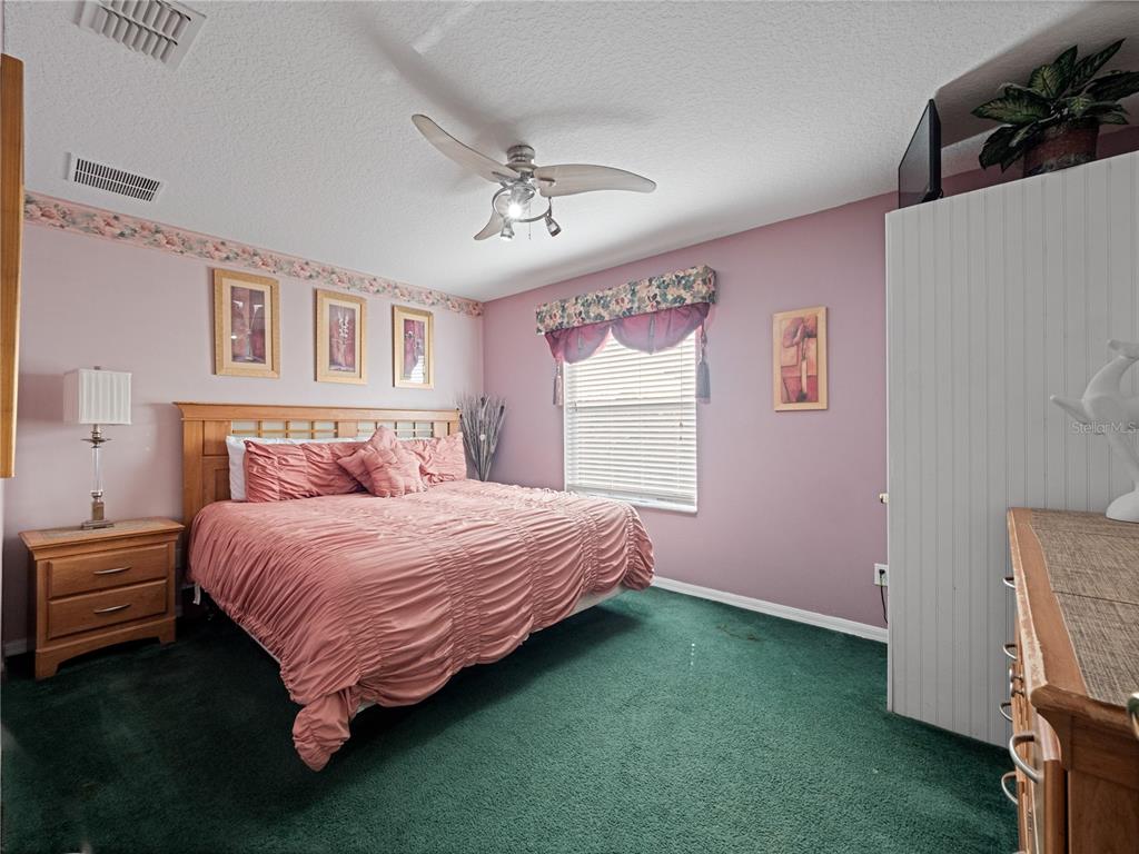 723 Wildflower Road Davenport, FL 33837 - Photo 20 of 34 a bedroom with a bed and a window