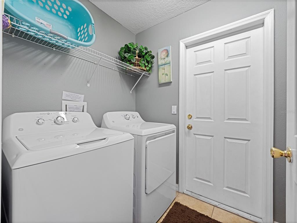 723 Wildflower Road Davenport, FL 33837 - Photo 25 of 34 a utility room with dryer and washer