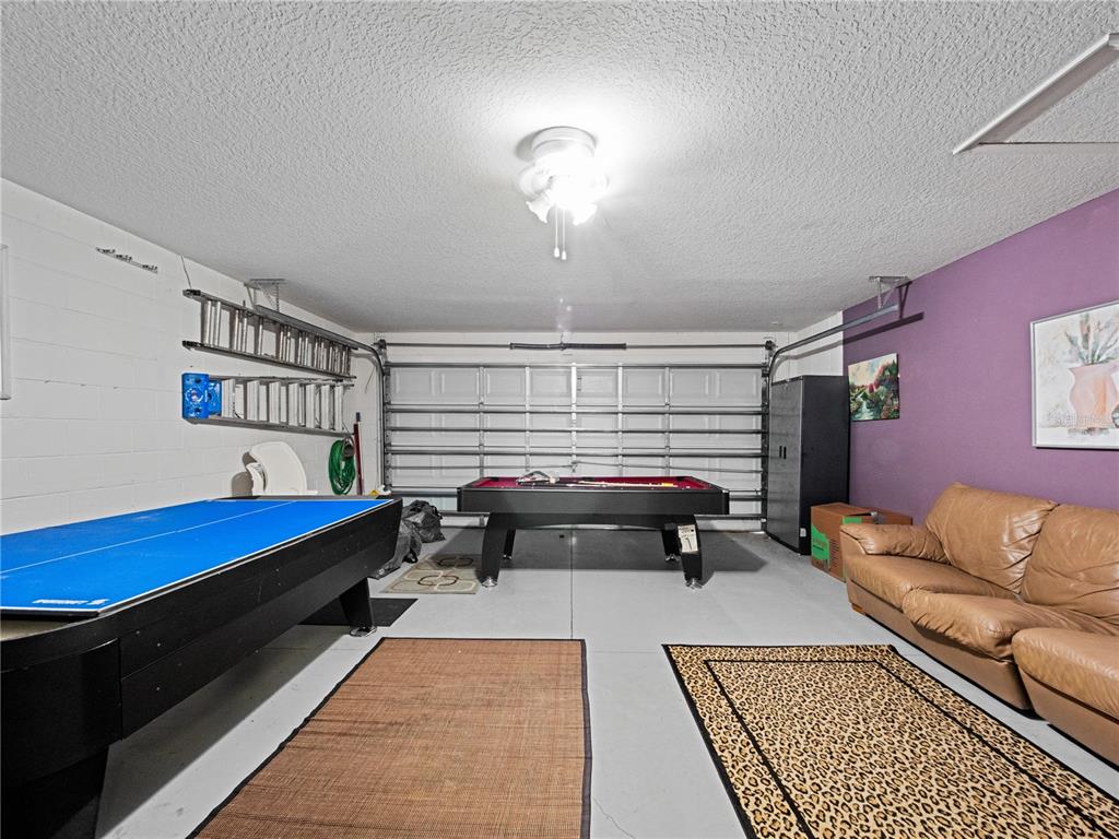 723 Wildflower Road Davenport, FL 33837 - Photo 27 of 34 a bedroom with furniture and a couch