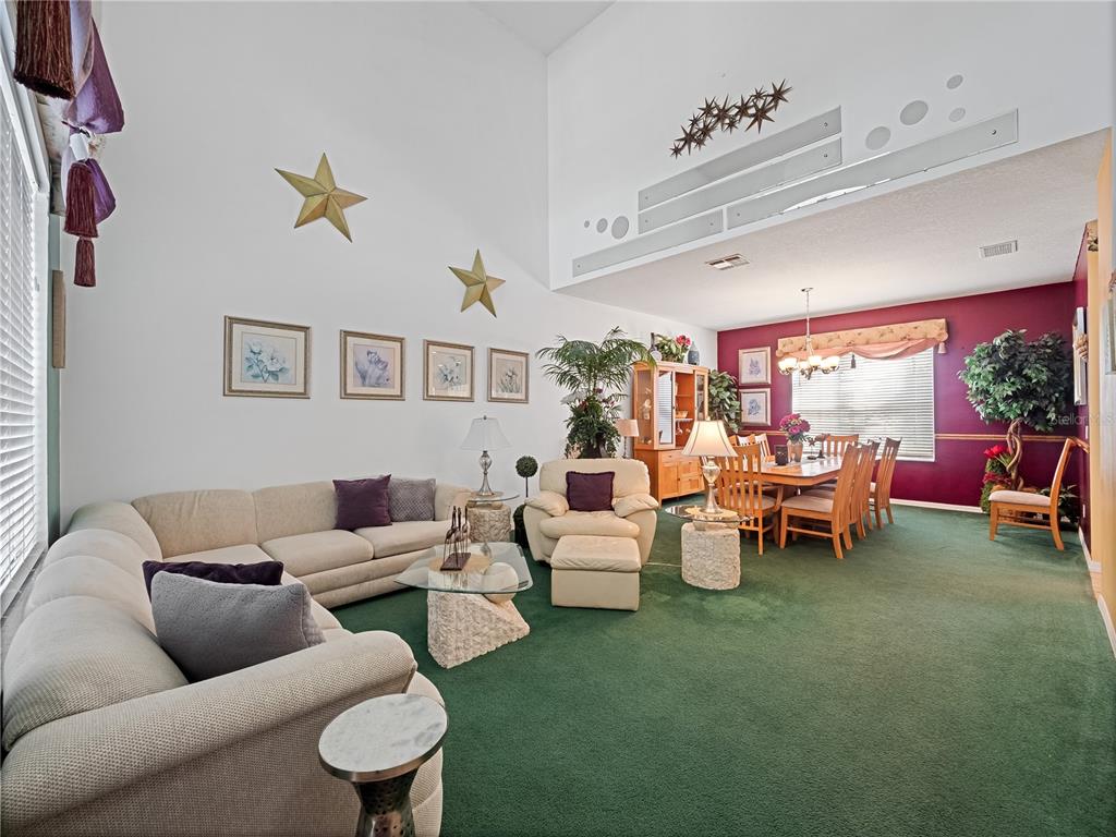 723 Wildflower Road Davenport, FL 33837 - Photo 5 of 34 a living room with furniture and a large window