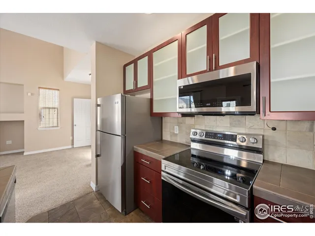 a kitchen with stainless steel appliances a stove a microwave and a refrigerator