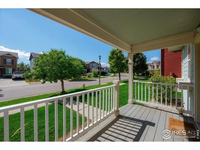 a view of a wooden deck with a yard