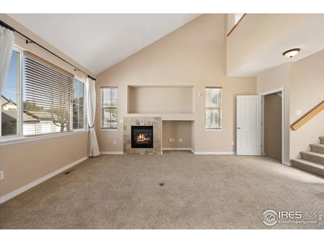 a view of empty room with a fireplace