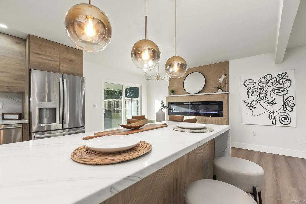 6802 Maury Drive San Diego, CA 92119 - Photo 11 of 44 a kitchen with a table and chairs