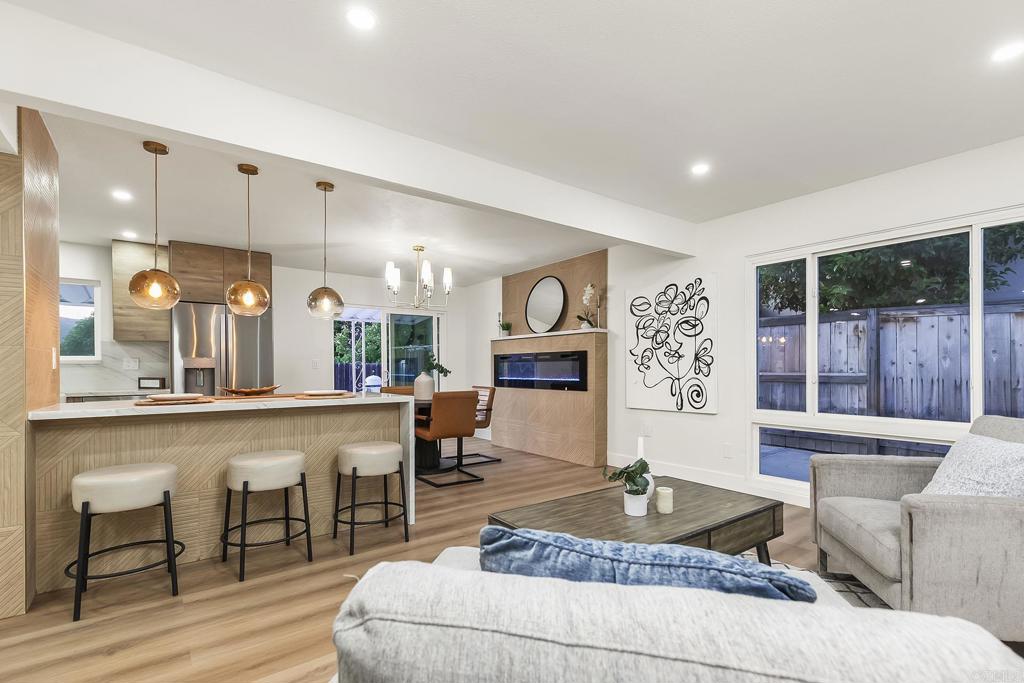 6802 Maury Drive San Diego, CA 92119 - Photo 12 of 44 a living room with fireplace furniture and a large window
