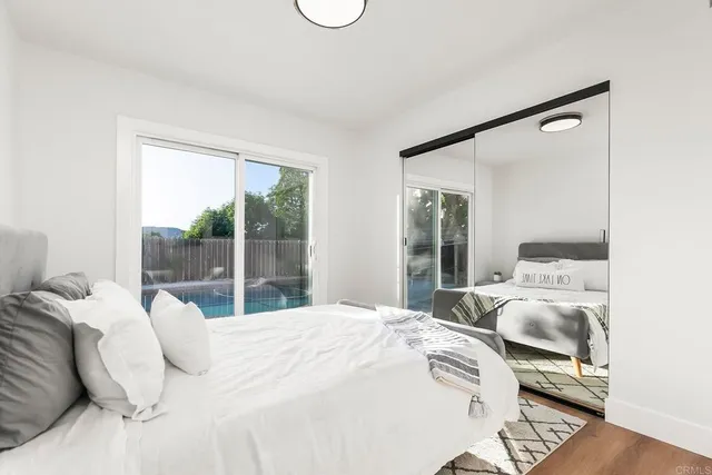 a bedroom with a large bed and a large window