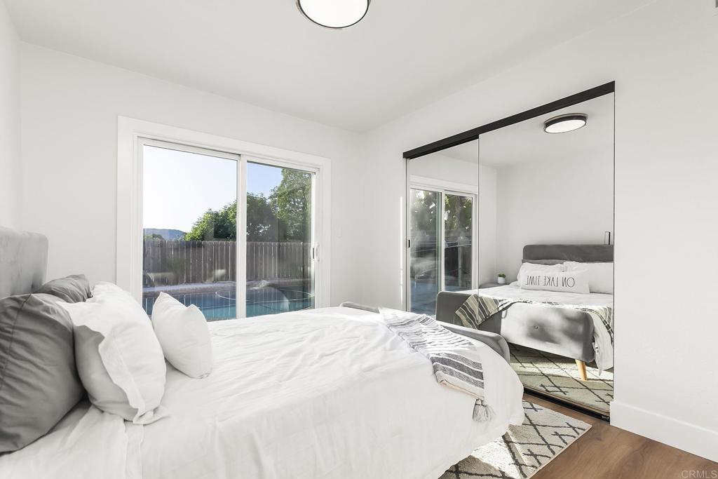 6802 Maury Drive San Diego, CA 92119 - Photo 20 of 44 a bedroom with a large bed and a large window