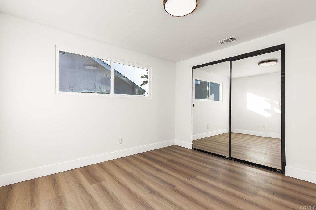 6802 Maury Drive San Diego, CA 92119 - Photo 22 of 44 a view of empty room with wooden floor