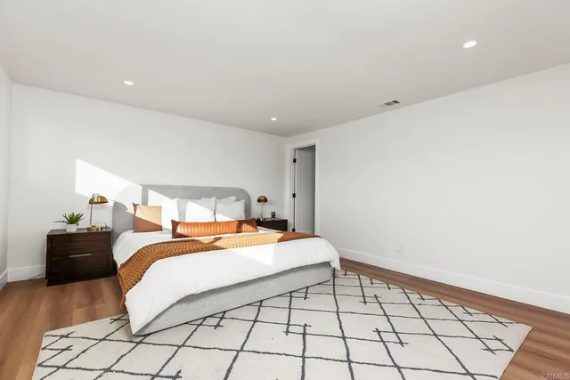 a bedroom with a bed and a lamp