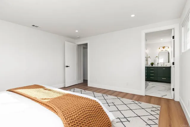 a bedroom with a bed and a view of bathroom