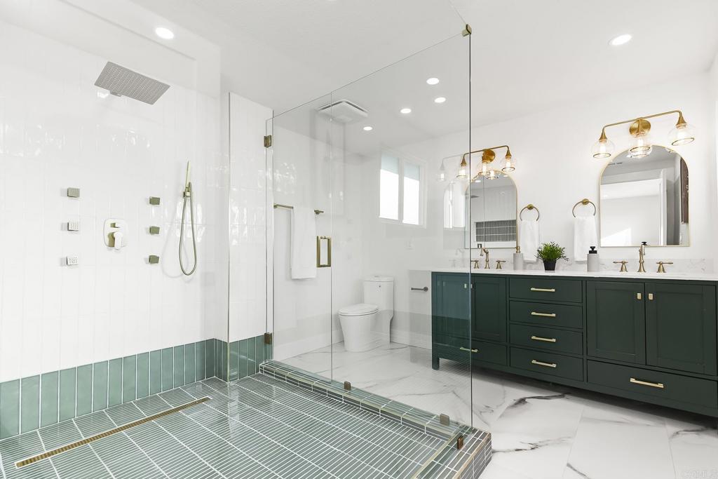 6802 Maury Drive San Diego, CA 92119 - Photo 29 of 44 a spacious bathroom with a double vanity sink a toilet and a mirror