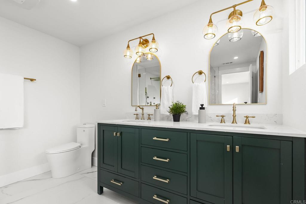 6802 Maury Drive San Diego, CA 92119 - Photo 30 of 44 a bathroom with a toilet sink and mirror