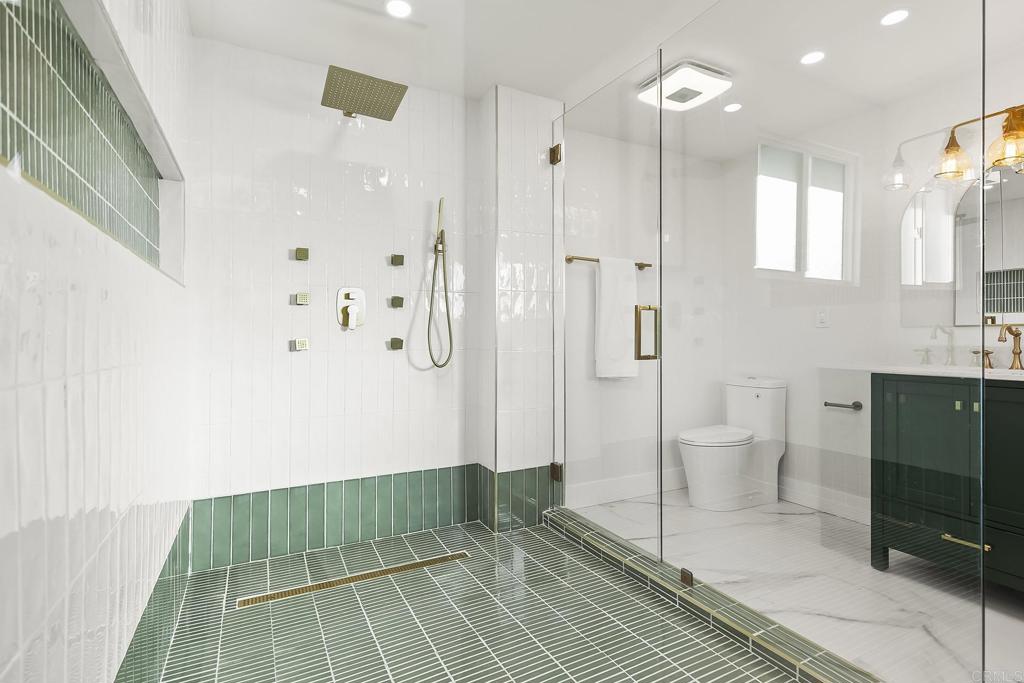 6802 Maury Drive San Diego, CA 92119 - Photo 32 of 44 a bathroom with a sink a toilet and shower