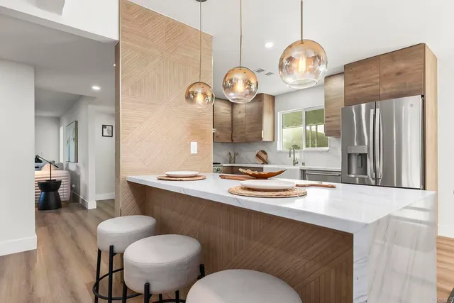 a kitchen with a sink cabinets and wooden floor