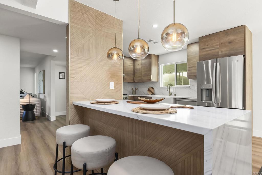 6802 Maury Drive San Diego, CA 92119 - Photo 4 of 44 a kitchen with a sink cabinets and wooden floor