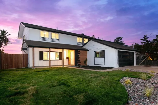 a front view of a house with a yard