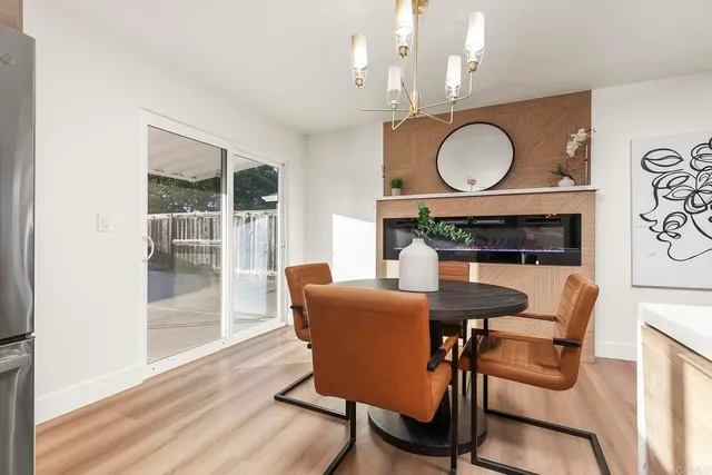 a view of a dining room with furniture a chandelier and wooden floor