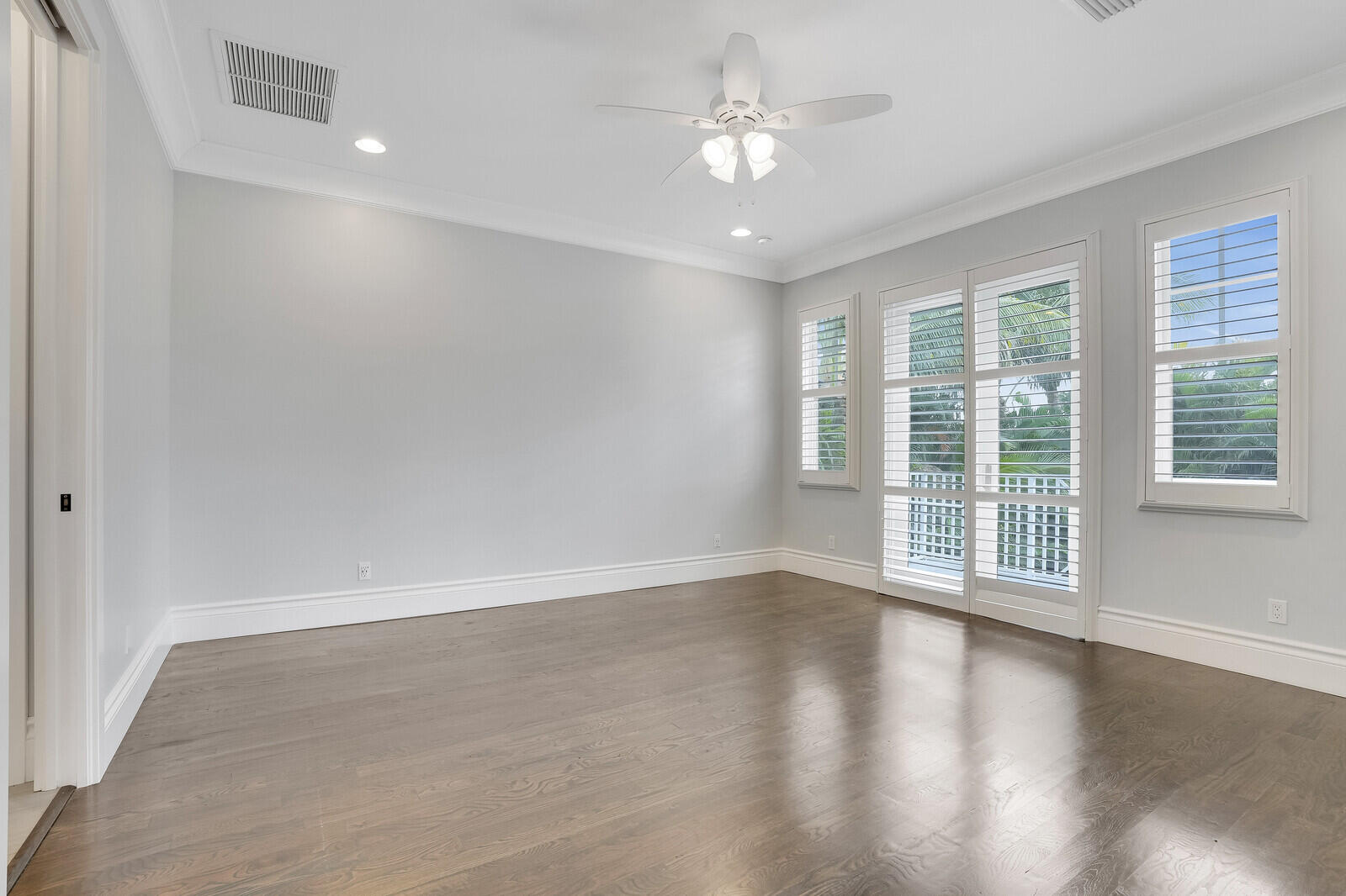 200 Northwest 10th Street Boca Raton, FL 33432 - Photo 28 of 76 an empty room with wooden floor and windows