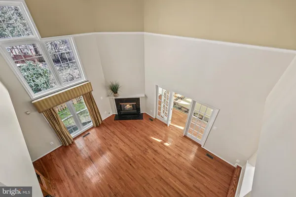 a view of a big room with wooden floor and a bathroom
